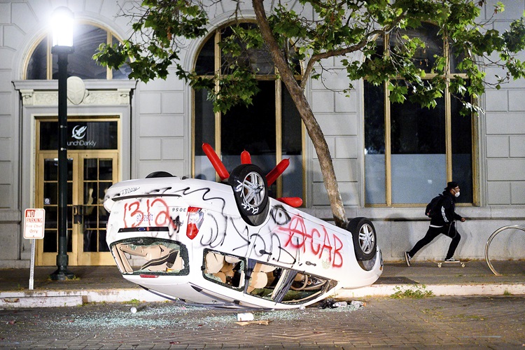 Vandalized cars sit in a Mercedes-Benz of Oakland showroom during in Oakland, 